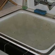 A sink filled with dirty water