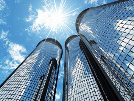 three glass buildings close together