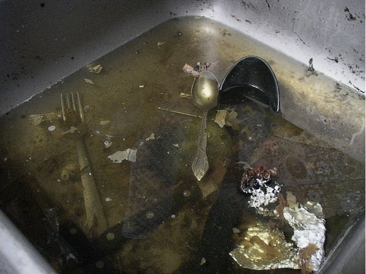 clogged bathroom sink with sitting water