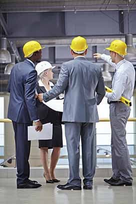 Three executive talking at a site