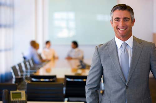 smiling man in board room