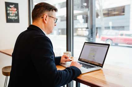 Man in suit on a laptop