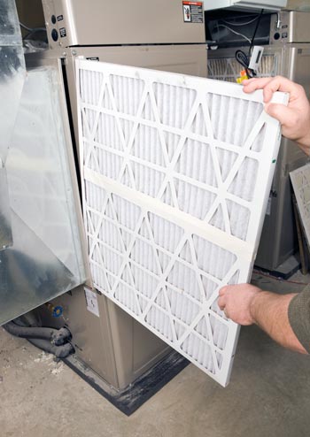 HVAC technician showing what a clean filter looks like